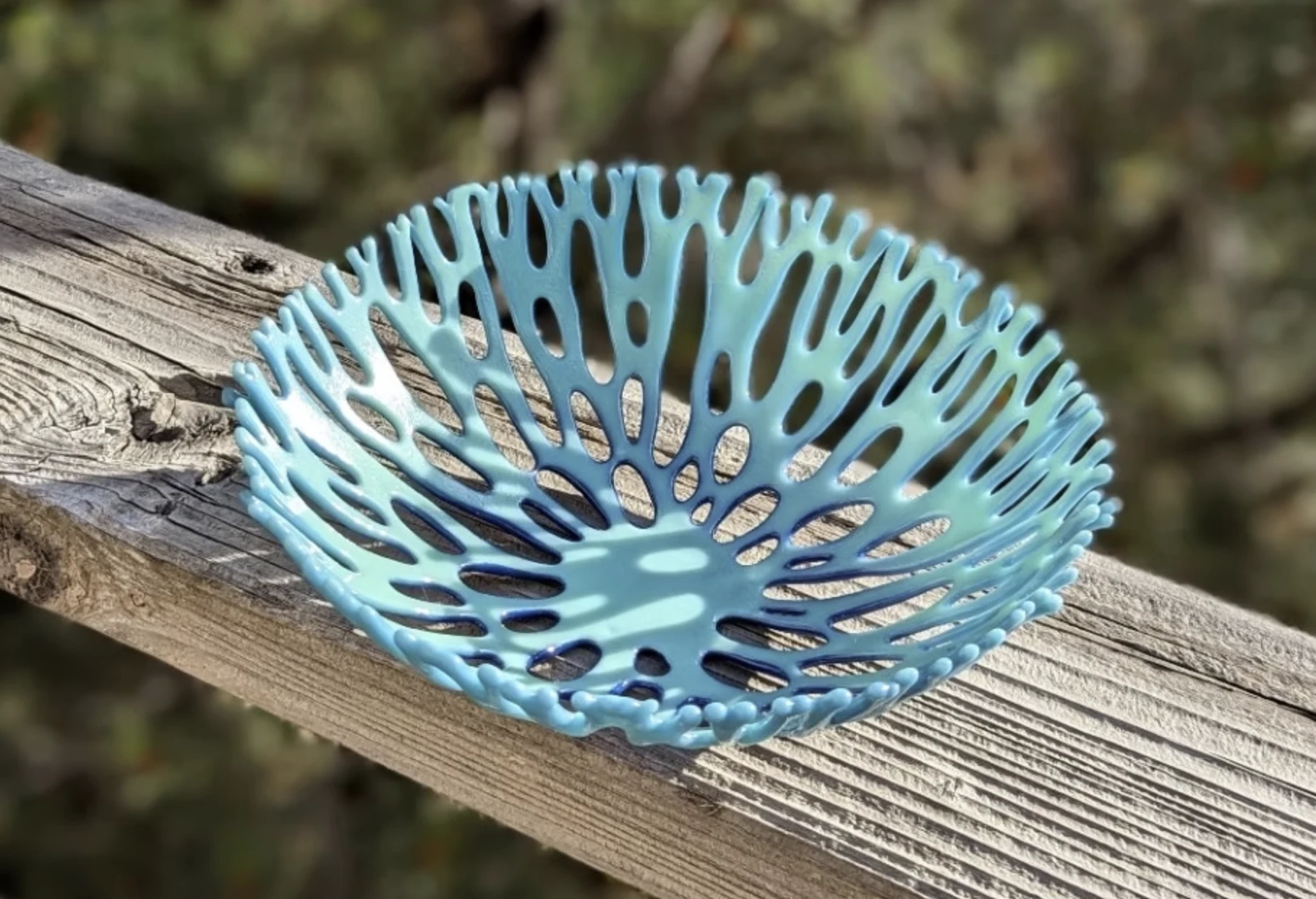 Openwork fused-glass bowl in aqua resembling branching coral